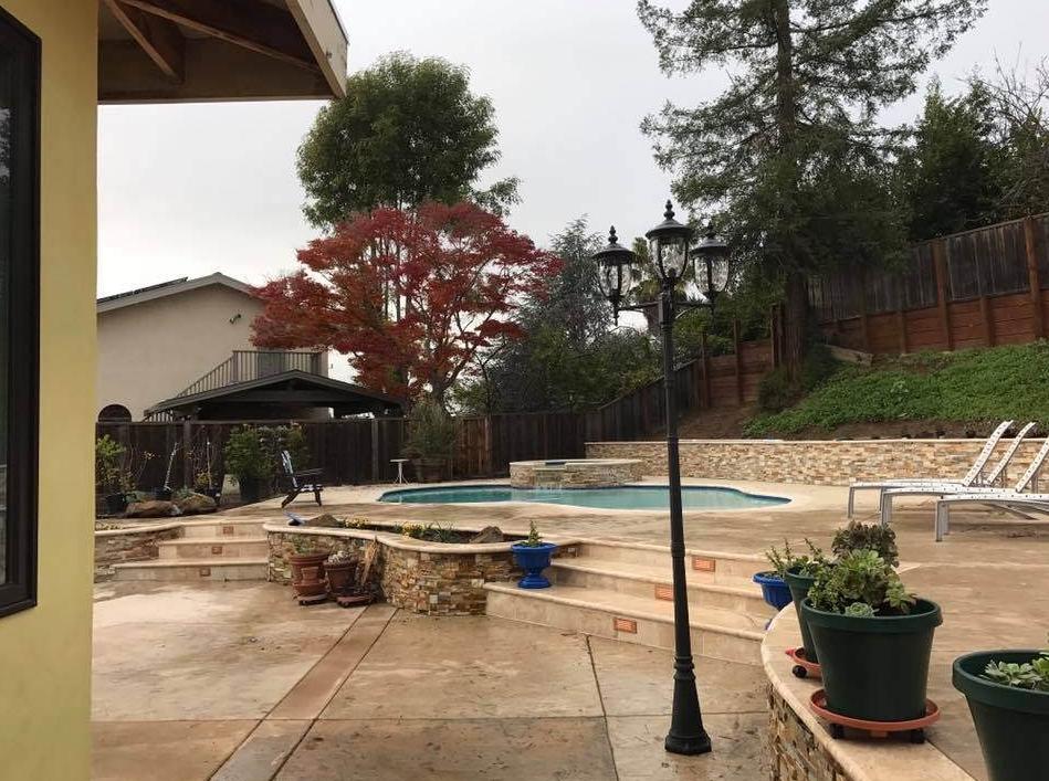 Picture of a concrete patio, stairs, and pool deck